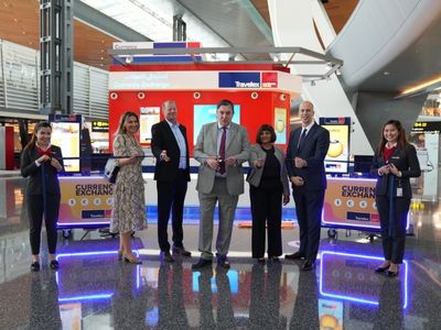 Travelex retail store with people cutting a ribbon to open it