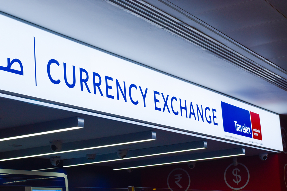White sign with text reading currency exchange Travelex
